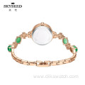 SKYSEED emerald type mother-of-pearl watch